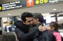 Iranian citizen and U.S green card holder Cyrus Khosravi greets his niece and brother after they were detained for additional screening following their arrival to Seattle-Tacoma International Airport to visit Cyrus, in SeaTac, Washington, U.S.