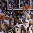 Spurs' Duncan shoots over Heat's James and Andersen during Game 1 of their NBA Finals basketball playoff in Miami