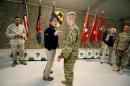 U.S. Defense Secretary Ash Carter, left, speaks with a soldier at Kandahar Airfield in Afghanistan, Sunday, Feb. 22, 2015. Carter is making his first trip to visit troops and commanders in Afghanistan since his swearing-in this week. (AP Photo/Jonathan Ernst, Pool)