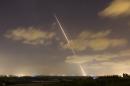 A streak of light is seen as a rocket is launched from the northern Gaza Strip towards Israel