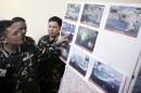 FILE - In this April 20, 2015 file photo, Armed Forces of the Philippines Chief of Staff Gen. Gregorio Pio Catapang, left, points to reveal recent images of China's reclamation activities being done at the disputed islands in the South China Sea during a news conference at Camp Aguinaldo at suburban Quezon city, northeast of Manila, Philippines. The dispute over the strategic waterways of the South China Sea has intensified, pitting a rising China against its smaller and militarily weaker neighbors who all lay claim to a string of isles, coral reefs and lagoons known as the Spratly and the Paracel islands. (AP Photo/Bullit Marquez, File)