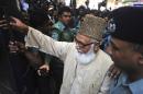 Matiur Rahman Nizami, head of the country's main Islamist opposition party Jamaat-e-Islami, enters a prison van at a court in Chittagong, Bangladesh, Thursday, Jan. 30, 2014. Nizami was among 14 people sentenced to death on Thursday on charges of smuggling weapons to a rebel group in neighboring India. (AP Photo/Khurshed Rinku)