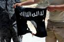 Syrian soldiers set fire to an Islamic State (IS) group flag in the province of Homs in central Syria