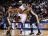 Miami Heat's LeBron James is defended by Utah Jazz Jamaal Tinsley and Randy Foye in Miami