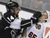 Los Angeles Kings right wing Justin Williams (14) fights with Chicago Blackhawks center Andrew Shaw (65) during the second period of Game 3 of the NHL hockey Stanley Cup playoffs Western Conference finals, Tuesday, June 4, 2013 in Los Angeles. (AP Photo/Jae C. Hong)