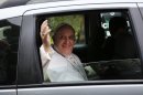Pope Francis waves to journalists from a car as he leaves the Sumare residency on his way to the Aparecida basilica for a Mass, in Rio de Janeiro, Brazil, Wednesday, July 24, 2013. Pope Francis returned to his home continent or the first time as pontiff, embarking on a seven-day visit meant to fan the fervor of the faithful around the globe. (AP Photo/Jorge Saenz)
