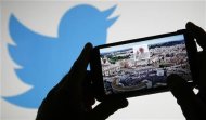 Pope Benedict XVI's twitter account is pictured on a smart phone in front of the Twitter logo displayed on a laptop in this photo illustration taken in Rome December 3, 2012. REUTERS/Max Rossi
