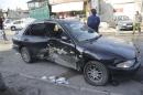 A damaged car is pictured after a mortar shell hit a textile factory at al-Dweil'a neighbourhood in Damascus