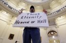 Anti-abortion supporter Juan Gaona, of San Antonio, holds a sign as he prays in the rotunda of the Texas Capitol, Monday, July 8, 2013, in Austin, Texas. The fight over access to abortion in Texas resumed Monday with thousands expected to attend a marathon Senate hearing and a nighttime anti-abortion rally at the Capitol. (AP Photo/Eric Gay)