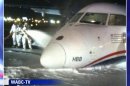 In this image taken from video and provided to WABC TV News by an airport source, emergency personnel spray foam on the fuselage of a US Airways Express commuter plane after it made a belly landing at Newark Liberty International Airport, Saturday, May 18, 2013, in Newark, N.J. The turboprop plane reportedly left Philadelphia shortly before 11 p.m., Friday, and landed safely at Newark with its landing gear retracted at about 1 a.m., Saturday. There were no injuries. (AP Photo/WABC TV News) MANDATORY CREDIT; NYC OUT