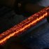 A hot steel bar is processed at the factory of Swiss Steel AG which is partly owned by the 'Schmolz + Bickenbach' group in Emmenbruecke, outside Lucerne