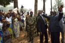 Interim Central African President Alexandre-Ferdinand Nguendet (R) greets people at the Isamo gendarmerie camp in Bangui on January 13, 2014