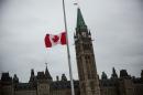 A flag next at the Canadian Parliament Building is flown at half staff on October 23, 2014 in Ottawa, Canada