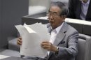 Tokyo Governor Ishihara organises his documents after delivering a policy speech at Tokyo metropolitan assembly in Tokyo