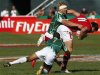 South Africa's Brown and Dazel tackle Wales' Smith during their Sevens World Series Plate semi-final rugby match at The Sevens stadium in Dubai