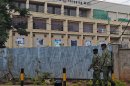 Police officers walk past the Westgate mall in Nairobi on September 28, 2013 where forensic experts are still collecting evidence after a deadly four-day siege of the prestigious shopping mall that left close to 70 people dead