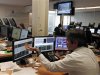 Trader gestures while watching screens in a trading room in Lisbon