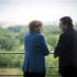 German Chancellor Merkel speaks with European Commission President Barroso at the start of their meeting at the Chancellery in Berlin