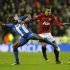Wigan Athletic's Figueroa challenges Manchester United's Van Persie during their English Premier League soccer match at The DW Stadium in Wigan
