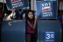 Camila Rivera, 11, joins postal workers in a national day of protest in Los Angeles