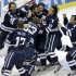 Yale goalie Jeff Malcolm (33) is swarmed by teammates after shutting out Quinnipiac  and leading the Bulldogs to a 4-0 win in the NCAA men's college hockey national championship game in Pittsburgh Saturday, April 13, 2013.  (AP Photo/Gene Puskar)