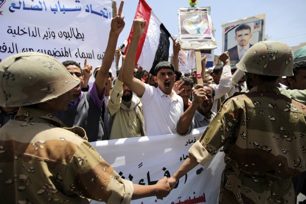 Defected army soldiers form a barrier during a protest in Sanaa