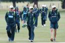 Members of the Australia cricket team, including captain Michael Clarke (C), and Nathan Lyon (R) walk out for a practice session at Old Merchant Taylors' School near Watford on June 21, 2015
