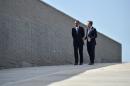 US President Barack Obama (L) walks with Argentinian President Mauricio Macri at the "Parque de la Memoria" (Remembrance Park) in Buenos Aires on March 24, 2016