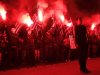 Supporters of the extreme-right Golden Dawn party hold flares as the chant the national anthem during a rally in Athens