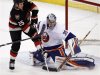 Islanders goalie DiPietro makes a save against Senators Neil during their NHL hockey game in Ottawa