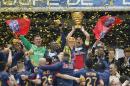 Paris Saint Germain's Thiago Motta, center, of Italy, and teammates celebrate with the cup after winning their French League Cup final soccer match against Lyon at the Stade de France in Saint Denis, north of Paris, Saturday April 19, 2014. (AP Photo/Jacques Brinon)
