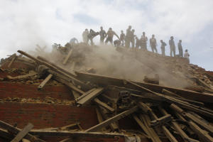 Volunteers help remove debris of a building that collapsed&nbsp;&hellip;
