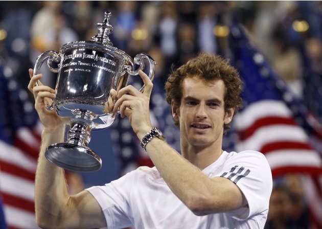 Britain's Murray receives the trophy after defeating Serbia's Djokovic in the men's singles final match at the U.S. Open tennis tournament in New York