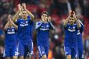 Chelsea players including Oscar, centre, celebrate after their 2-1 win during the English Premier League soccer match between Liverpool and Chelsea at Anfield Stadium, Liverpool, England, Saturday Nov. 8, 2014. (AP Photo/Jon Super)