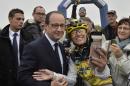 A fan takes a selfie with French President Francois Hollande, left, during the sixth stage of the Tour de France cycling race over 194 kilometers (120.5 miles) with start in Arras and finish in Reims, France, Thursday, July 10, 2014. (AP Photo/Jeff Pachoud, Pool)