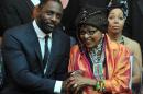 Nelson Mandela's second wife Winnie Madikizela–Mandela (R) and British actor Idris Elba, who plays the role of Nelson Mandela in the movie "Mandela, Long Walk to Freedom", attend the movie's premiere in Johannesburg on November 3, 2013