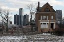 A vacant, boarded up house is seen in the once thriving Brush Park neighborhood with the downtown Detroit skyline behind it in Detroit,
