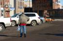 Eric Held carries water to his vehicle at a public distribution center, Tuesday, Jan. 20, 2015, in Glendive, Mont. A cancer-causing component of oil has been detected in the Glendive drinking water supply, just downstream from a crude oil spill that entered the Yellowstone River. (AP Photo/Matthew Brown)