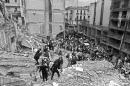 Firemen and policemen search for wounded people after a bomb exploded at the Argentinian Israeli Mutual Association (AMIA in Spanish) in Buenos Aires, July 18, 1994