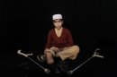 In this Thursday, Feb. 21, 2012, photo, Pakistani student Hazratullah Khan, 14, who was injured in a car bombing on December 17, 2012 in Peshawar, poses for a picture in Peshawar, Pakistan. Hazratullah Khan's right leg was amputated below the knee after he survived a car bombing as he was on his way home from school. His response when asked whether peace talks should be held with the Taliban leaders who ordered attacks like the ones that maimed him is simple: Hang them alive. Slice their flesh off their bodies and cut them into pieces. (AP Photo/Muhammed Muheisen)