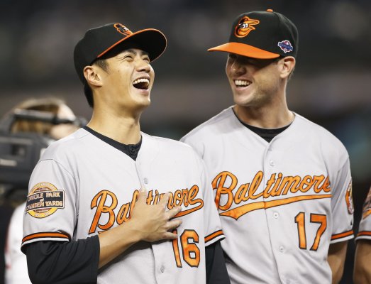 Baltimore Orioles starting pitchers Chen Wei-Yin and Brian Matusz laugh before Game 3 of their MLB ALDS baseball playoff series against the New York Yankees in New York