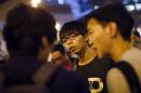 Joshua Wong, leader of the student movement, talks to reporters outside the government headquarters office in Hong Kong