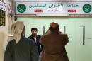 Jordanians check the main entrance of the Muslim Brotherhood's office in Amman, which was shut by police on April 13, 2016