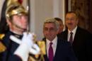 Armenia's President Sargsyan and Azerbaijan's President Aliyev leave after a dinner at the Elysee Palace in Paris