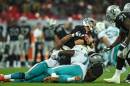 Oakland Raiders' Matt McGloin reacts as he is sacked during the NFL football game against Miami Dolphins at Wembley Stadium in London, Sunday, Sept. 28, 2014. (AP Photo/Tim Ireland)