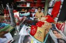 A party member sells party memorabilia at National League for Democracy stand at party's head office in Yangon
