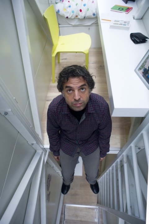 World's thinnest house Keret at desk looking up