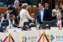 Greek Prime Minister Alexis Tsipras, center right, shakes hands with German Chancellor Angela Merkel, center left, at the start of a round table meeting at the EU-CELAC summit in Brussels on Wednesday, June 10, 2015. Greece's prime minister was hoping to meet with the leaders of Germany and France in Brussels Wednesday, in the latest effort to break a bailout negotiation deadlock that has revived fears his country could default and drop out of the euro. (AP Photo/Geert Vanden Wijngaert)