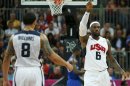 James of the U.S. celebrates after a basket as team mate Williams watches during their men's Group A basketball match against France at the London 2012 Olympic Games in the Basketball arena