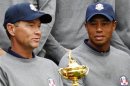 U.S. golfer Woods looks at the Ryder Cup as it is held by captain Love III during the 39th Ryder Cup golf matches at the Medinah Country Club in Medinah